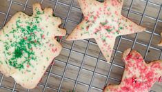 four cookies with sprinkles on a cooling rack, one is cut in half to look like stars