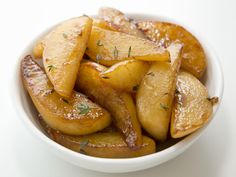 a white bowl filled with sliced apples covered in sugar