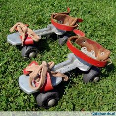 two toy cars are sitting in the grass