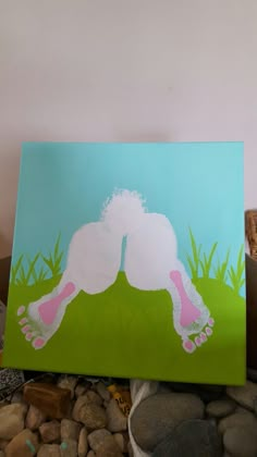 a painting of a person laying on the ground with grass and rocks in front of it