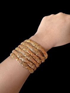 This beautiful set of six gold-plated bangles are perfect for any occasion! Their size of 2.6 inches make them the perfect accessory for any look. Whether you're gifting them to a loved one or keeping them for yourself, these bangles will add a touch of sparkle to any outfit. Ready to ship for instant statement-making! Features: Entirely unique set of four bangles with genuine gold plating Dynamic and interesting jewelry set Can be worn together or pieced with other bracelets Perfect for a night Gold Stackable Bangle For Festivals, Traditional Rose Gold Bangle Bracelets, Traditional Rose Gold Bangle Bracelet, Traditional Gold Stackable Bangle, Gold Stackable Bangle For Weddings, Festive Gold Stackable Bangle, Traditional Rose Gold Bangle As Gift, Interesting Jewelry, Gold Plated Bangles