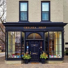 the chelsea shop is located in an old brick building with many windows and plants outside