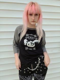 "Important Announcement!!  We will be overhauling our brand in the new year and many designs will be retired! Be sure to grab any favorites now before they are gone! Our adorably badass Jrock Bunny is rocking his visual kei style on this raglan tee. These two-color unisex raglan shirts are made of a lightweight, buttery-soft polyester/cotton blend, and are amazingly comfortable! The 3/4 length sleeves hit just below the elbow, with contrast color sleeves for a stylish colorblock look. ☆ For more Edgy Anime Print T-shirt For Alternative Fashion, Harajuku Long Sleeve Tops For Alternative Fashion, Alternative Cotton Tops For Cosplay, Alternative Style Cotton Tops For Cosplay, Harajuku Style Black T-shirt For Concerts, Black Harajuku T-shirt For Concert, Emo Long Sleeve T-shirt For Alternative Fashion, Emo Style Long Sleeve T-shirt, Emo Cotton Tops For Cosplay