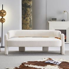 a white couch sitting on top of a carpet covered floor