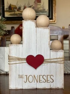 a wooden block with a heart and the words the joness on it