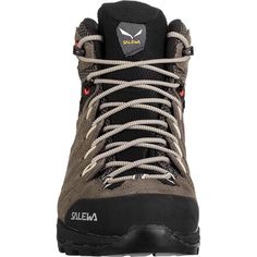 the side view of a hiker's hiking boot with black and grey laces