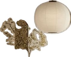 two paper lanterns hanging from the ceiling and one is decorated with gold leaf designs on it