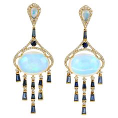 Handcrafted from 14-karat gold, these exquisite drop earrings are set with 14.99 carats Ethiopian Opal, 2.81 carats blue sapphire and .98 carats of glimmering diamonds. FOLLOW MEGHNA JEWELS storefront to view the latest collection & exclusive pieces. Meghna Jewels is proudly rated as a Top Seller on 1stDibs with 5 star customer reviews. All items manufactured by us are handmade and can be customized or redesigned. Composition Size - 56X20 MM Gold Weight - 10.509 gm Gemstone - Opal Ethiopian (14. Vintage Drop Earrings, Sparkle Jewelry, Blue Sapphire Diamond, Top Seller, Product Photos, Sapphire Diamond, Ear Jewelry, Ear Wire, Ethiopian Opal