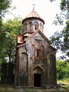 an old stone church with a clock tower