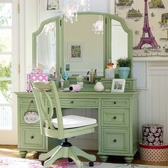 a green desk with a chair and mirror