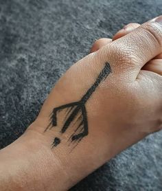 a person's hand with a tattoo on it