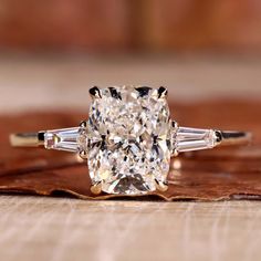 a cushion cut diamond ring with three baguets