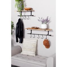 three shelves with hooks and hats on them