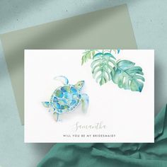 a card with a watercolor painting of a sea turtle and tropical leaves on it