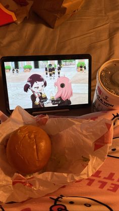 a cell phone sitting on top of a bag next to a sandwich