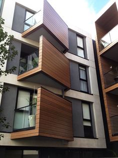 an apartment building with wooden balconies on the side