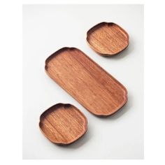 two wooden trays sitting next to each other