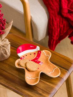 a wooden table topped with a gingerbread shaped cookie