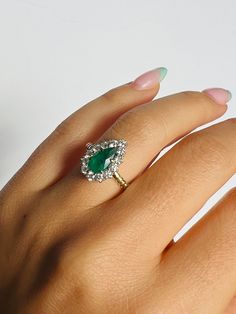 Inspired by a gorgeous Edwardian piece, this pear cut emerald and diamond halo ring makes for the perfect statement piece or engagement ring. She has a low profile, making her easy to wear! Emerald: pear shape 9.2x5mmDiamonds: 13 stones ~ 0.42ctWeight: 4 - 5 grams 14k yellow and white gold Emerald Stone Engagement Ring Pear, Emerald Pear Diamond Ring, Pear Emerald Ring, Emerald Pear Engagement Ring, Kerri Maniscalco, Trendy Engagement Rings, Pear Cut Ring, Vintage Halo, Emerald Rings