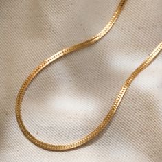 "Our herringbone necklace is gorgeous, catches light and shimmers perfectly. This gold chain necklace will be your go-to everyday statement jewelry piece that you don't want to miss on. It can be worn on both casual and fine nights out and this chunky gold necklace will be a great addition to your layered necklace collection. D E T A I L S * 14K gold filled herringbone chain necklace * Width: 3 mm * Lobster clasp * Nickel-free L E N G T H * 16\" (40.6 cm) * 16\" with 2\" extender (Total length: Chic Gold Herringbone Necklace With Delicate Chain, Gold Herringbone Necklace With Box Chain For Everyday, Gold Herringbone Necklace With Box Chain, Gold Minimalist Herringbone Choker Necklace, Gold Minimalist Snake Chain Choker, Gold Minimalist Herringbone Choker, Gold Herringbone Necklace With Adjustable Chain For Everyday, Minimalist Herringbone Link Necklace With Adjustable Chain, Everyday Gold Plated Herringbone Necklace