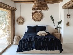 a bed room with a neatly made bed and some hanging baskets on the wall above it