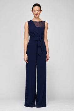 The Aubree Jumpsuit, crafted from stretch scuba crepe, offers versatile elegance with its sleeveless design, asymmetric overlay bodice, and sheer yoke. The palazzo pants, oversized decorative bow at the waistband, and timeless navy hue make it a chic choice for both formal and semi-formal occasions. Details Asymmetric Neck Jumpsuit Silhouette Wide Leg Sleeveless Floor Length Knit REF: 86411860 Fancy Cocktail Dress, Semi Formal Wedding Attire, Formal Wedding Guest Attire, Bow Jumpsuit, Wedding Attire For Women, Office Party Outfits, Jumpsuit Formal, Wedding Pantsuit, Formal Wedding Attire