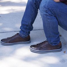 Men's long facing six (6) eyelet derby shoe in full grain soft burnished and polished leather featuring a comfortable padded sports style top-line with contrast leather logo and heel trim, all on a three-color side wall stitched rubber out-sole. Brown Low-top Lace-up Shoes For Business Casual, Masculine Brown Lace-up Oxfords, Brown Low-top Shoes For Business Casual, Brown Low-top Leather Derby Shoes, Casual Brown Cap Toe Lace-up Shoes, Brown Stitched Sole Lace-up Shoes For Business Casual, Masculine Brown Low-top Leather Shoes, Brown Lace-up Shoes With Stitched Sole For Business Casual, Brown Casual Cap Toe Leather Shoes