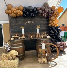 an outdoor display with balloons and wine barrels