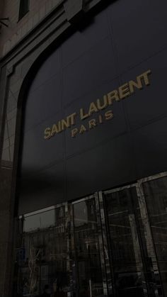 the entrance to saint laurent paris is lit up in black and gold letters that spell out it's name