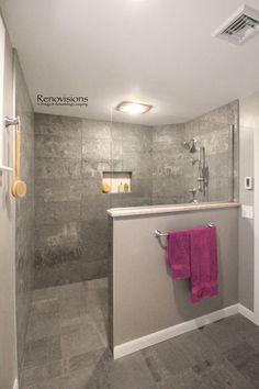 a bathroom with a sink, shower and towel rack on the wall next to it