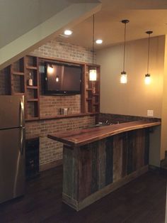 a kitchen with an island in the middle and lots of lights hanging from the ceiling