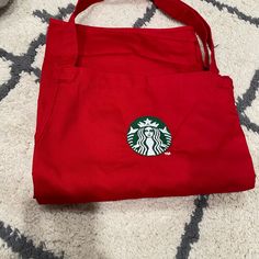 a red starbucks bag sitting on top of a white rug