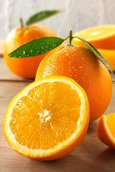 an orange cut in half on a wooden table