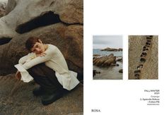 a woman sitting on top of a rock next to the ocean