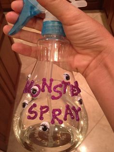 a hand holding a bottle with the word finish spray written on it and a blue plastic spout