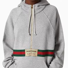 Reminiscent Of A Vintage Tracksuit, This Hooded Sweatshirt Features A Front Zip Detail And Contrast Red Piping. Emblematic House Codes, Like The Green And Red Web Stripe And The Gucci Jacquard Label, Enrich The Design. Gucci Gray Sweatshirt With Gucci Logo And Web Gray Heavy Felted Cotton Jersey Green And Red Web Stripe Gucci Jacquard Label Fixed Hood Partial Zip Front Pocket Oversized Top Fabric: 100% Cotton. Details: 44% Acrylic, 44% Wool, 12% Viscose. Application: 100% Polyester. Size L Produ Gucci Sporty Sweatshirt With Logo Detail, Gucci Sporty Sweatshirt For Fall, Gucci Cotton Sweatshirt With Logo, Fire Fashion, Gucci Hoodie, Vintage Tracksuit, Gucci Shirts, Gucci Design, Red Web