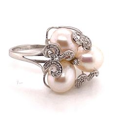 Gold Diamond and Pearl Pave Flower Cluster Cocktail Ring Perfect For everyday wear a special occasion and makes the perfect gift. Details: Diamonds and Pearl 14KT White Gold Ring Measures Approx 16.5mm Wide Weight 4.1 Grams Ring Size 7 Ring Can be sized upon request Comes in a presentable gift box Luxury Cluster Pearl Ring As A Gift, Elegant Formal Flower Shaped Ring, Elegant Flower Rings For Anniversary, Elegant Flower-shaped Rings For Anniversary, Elegant White Flower Shaped Ring, Elegant White Flower Shape Ring, Elegant White Flower-shaped Ring, Classic Formal Rings With Flower Shape, Classic Formal Ring With Flower Shape