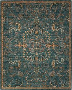 a blue area rug with an ornate design on the front and back side, in various colors