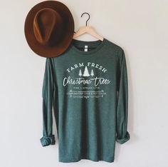 🌲 30% off when you buy 2 or more items! 📦 Shipping is FREE on all orders! 📫 Secure tracking provided right to your doorstep! Our buttery soft poly/cotton blend graphic tees are lightweight with the perfect amount of stretch. The unisex fit is comfortable and flatters all body types, our tees are truly a crowd favorite and sure to become a staple in your closet! All garments are hand printed to order in our Idaho based, family run shop! We screen print our T-Shirts with high quality ink as the Winter Holiday Cotton Shirt, Holiday Festive Long Sleeve Shirt, Festive Winter Shirt With Letter Print, Holiday Long Sleeve Shirt With Graphic Print, Festive Cotton Tops For Fall, Long Sleeve Christmas Holiday Shirt, Relaxed Fit Long Sleeve Holiday T-shirt, Relaxed Fit Long Sleeve T-shirt For Holiday, Christmas Long Sleeve Cotton Tops