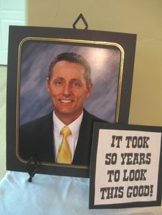 a man in a suit and tie with a sign that says it took 50 years to look this good