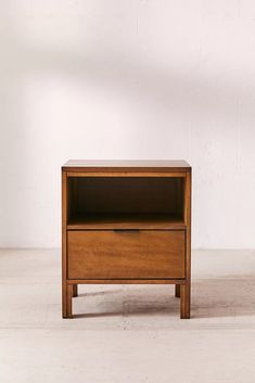 a small wooden table with one drawer open