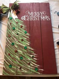 a christmas tree made out of wooden planks on top of a sheet of paper