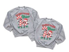 This retro Candy Cane Crew Christmas sweatshirt is perfect for any matching family this Holiday season and is a must have cozy staple for your your holiday wardrobe! This is our favorite holiday item to sport all Christmas season! ✨ HOW TO ORDER ✨ ✧ Select your options from the Drop Downs ✧ ADD TO CART • • • • • • • • • • • • • • • • • • • • • • • • • • • • • 👕 TOPS 👕 ✧TEE SHIRT - crew neck tee, unisex fit ✧SWEATSHIRT - soft and cozy crew neck in a classic fit, unisex sizing • • • • • • • • • • • • • • • • • • • • • • • • • • • • • 🎨 GRAPHIC DETAILS 🎨 ► Professional and Permanent Quality ► Vibrant and Accurate colors • • • • • • • • • • • • • • • • • • • • • • • • • • • • • 📋 CARE INSTRUCTIONS 📋 ✧ Wash Gentle Inside Out ✧ No Bleach or Bleach Substitutes ✧ Hang to Dry for longevity ✧ Family Matching Winter Tops For Gifts, Family Matching Graphic Print Tops For Winter, Green Family Matching Tops For Gift, Fun Long Sleeve Tops, Family Matching Shirts, Retro Candy, All Christmas, Candy Cane Christmas, Gifts For My Wife