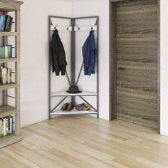 a coat rack with two coats hanging on it next to a book shelf filled with books