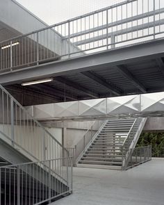 an empty parking garage with stairs and railings