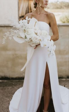 a woman in a white dress holding a bouquet