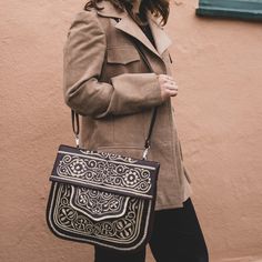 In Morocco, hand embroidery serves as a thread connecting generations, with mothers teaching daughters the craft. Embroidered designs can be found on various items in the souks—from handkerchiefs to poufs and bags—and the designs differ from city to city. This satchel, the perfect size for books, has proven itself a versatile companion for any adventure. 11" tall, 12" wide Detachable shoulder strap Embroidered leather Traditional Hand-stitched Bags For Everyday, Embroidered Brown Rectangular Satchel, Brown Embroidered Rectangular Satchel, Artisan Brown Embroidered Shoulder Bag, Artisan Embroidered Tote Shoulder Bag, Artisan Embroidered Shoulder Bag For Travel, Embroidered Brown Tote Satchel, Brown Embroidered Tote Satchel, Brown Embroidered Satchel For Travel