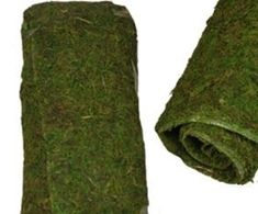 a roll of green moss sitting on top of a white surface next to it's wrapper