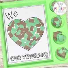 we love our veterans craft made with green paper and cut out hearts on a tray