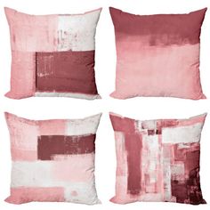 four pink and white pillows on a white background